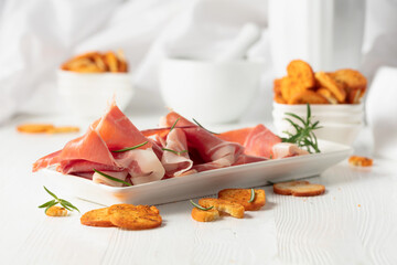 Prosciutto with rosemary and spicy bruschetta crackers.