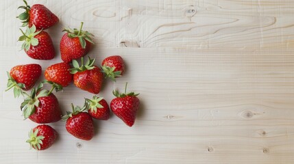 Fresh strawberries on a light wooden table minimalistic style vibrant red against neutral background 