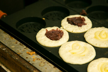 Traditional Japanese sweet stuffed azuki bean paste or anko at a Kyoto food market stall.