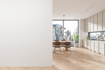 Beige kitchen interior with dining table and cabinets, blank wall