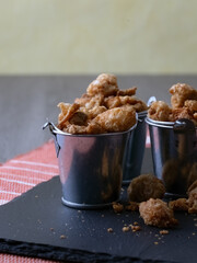 Snack of salted pork rind scratchings in miniature buckets