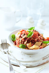 Pappardelle Pasta with Vegetables and fresh Basil on bright wooden Background