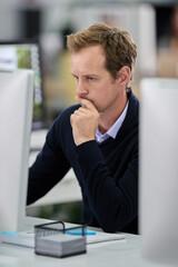 Serious, businessman and thinking at desk with computer and documents for research on company project. Male person and employee with tech working on idea or plan for corporate proposal in office