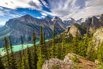 Stunning panoramic view of Lake Louise surrounded by rugged snow-capped mountains including Big...