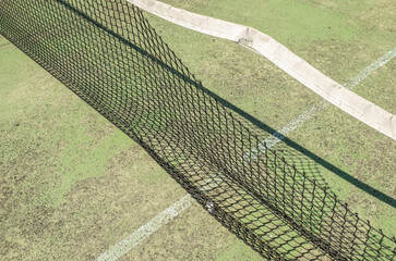detail of the netting of an abandoned and weathered paddle tennis court