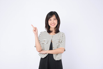 A Young asian woman pointing finger to free copy space isolated on white studio background