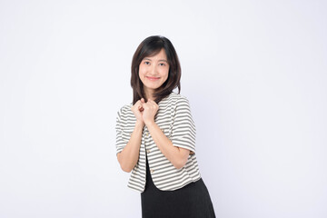 Asian woman is expressing delight against a white background.