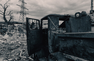 Fototapeta premium burnt cars and destroyed buildings of the workshop of the Azovstal plant in Mariupol