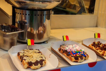 Belgian waffles with colorful sweet toppings and fruits for sale in Brussels, Belgium
