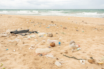 Obraz premium Sri Lanka, Bottles of plastic and garbage on the sand on the beach near the ocean, sea pollution catastrophe.