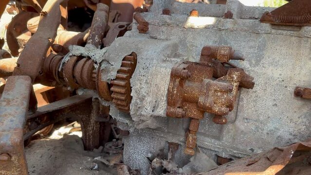 Inside wrecked infantry fighting vehicle there is crumpled metal, holes from shrapnel, rusty engine melted from fire. War in Ukraine