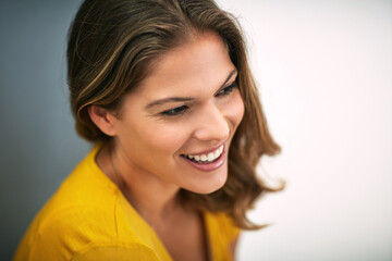 Naklejka premium Happy woman, smile and thinking on studio backdrop for relax, memory and optimistic on mockup. Female person, remember and nostalgia by grey background for daydream, ideas and laughing at joke