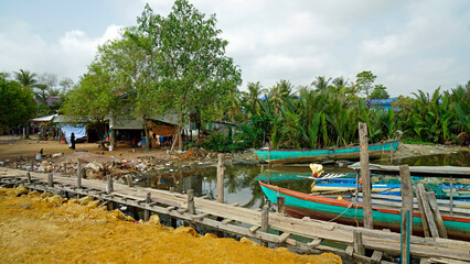 colorful fisher boats in a harbor in kampot