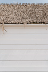 White wooden facade and straw thatched roof