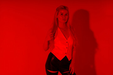 Beautiful young blonde woman through red filter