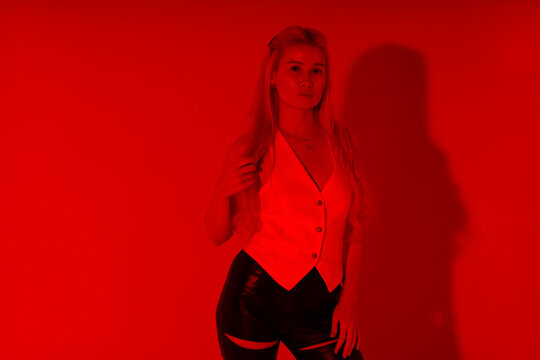 Beautiful young blonde woman through red filter