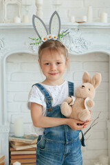 Cute 5 year old girl, with bunny ears, smiling. Easter. Studio. Close-up. Selective focus. Copyspace