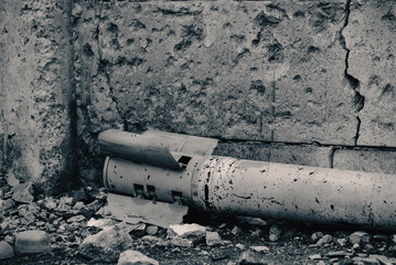 weapon rocket lying on the ground near the wall in Ukraine