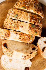 Fresh baked bread and sliced on wooden table.