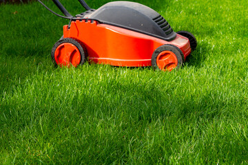 Seasonal maintenance works in garden, lawn movers in action, green grass cutting, lawn care,...