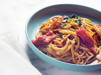 Chinese noodles with sun-dried tomatoes, herbs, garlic and tomato sauce