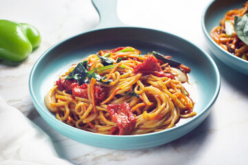 Chinese noodles with sun-dried tomatoes, herbs, garlic and tomato sauce