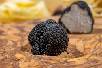 Cooking pasta with Italian black summer truffle, tasty aromatic mushroom, close up