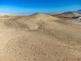 Fototapeta na wymiar Sandy dunes and hills on Jandia peninsula near Playas de Sotavento en Costa Calma touristic resort, Fuerteventura, Canary islands, Spain