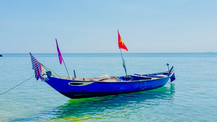 Fishing boat on cristal clear water in cham island, vietnam