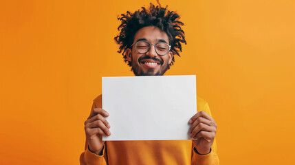  Man is holding up a blank whiteboard on isolated orange color background, vibrant, eye- catching, playfulness and fun
