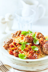 Spaghetti Pasta with Meatballs and fresh Basil o bright background. Close up.