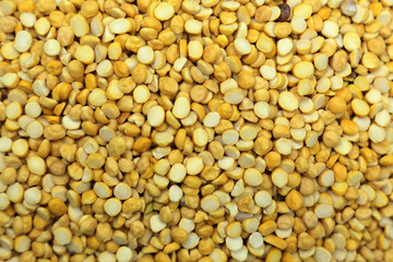 A Close Up of Yellow Chana Daal a Staple Ingredient in Indian Cuisine Against a Neutral Background