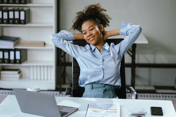 Businesswoman sitting in office chair relaxing, female feeling peaceful resting at workplace.