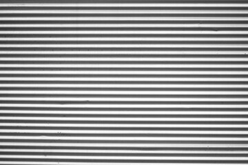 Silver tin iron corrugated wall with horizontal stripes from a metal profile of a metal sheet....