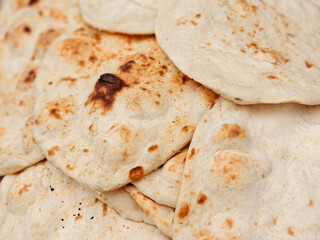 Fresh-baked flatbread (other names is pita, lavash, lafa, roti, chapati) for sale at the local city...