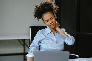 Businesswoman is doing a stretchy posture due to sitting in the office for too long, office...
