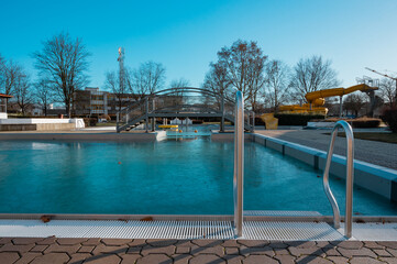 The swimming pool is closed for the winter season. Frozen water.