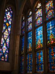Resplendent Sanctuary, Cathedral's Stained Glass Window Glowing with Vivid Colors Under the Brilliance of Sunlight Peering Through.
