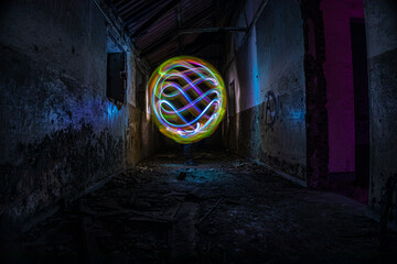 Rounded figure in an abandoned house. Lightpainting photography.