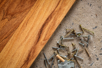 Screw, nail on concrete wood texture background. Closeup of screws and nails on cement and wooden...