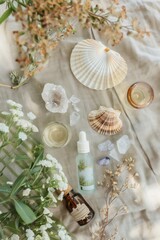 Top-view shot of a spa arrangement on a linen tablecloth: essential oils with vintage labels, a seashell, dried botanicals, and a crystal cluster
