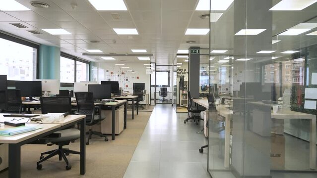 Interior of spacious creative coworking workspace with computer desks