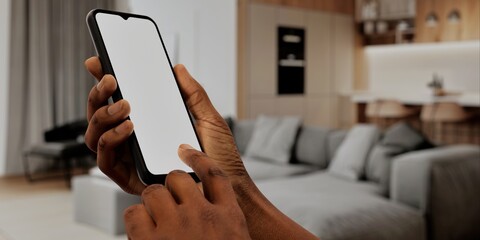 African-American Hand with smartphone in modern home, perfect for smart home app