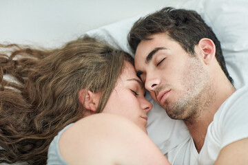 Obraz premium Relax, sleeping and couple hug in bed with love, safety or security, comfort and top view bonding at home. Peace, tired or people in bedroom with nap, snooze or lazy morning, dream or rest in a house