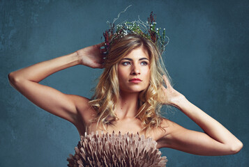 Nature, fashion and creative woman with flowers in crown in hair and clothes with feathers in...