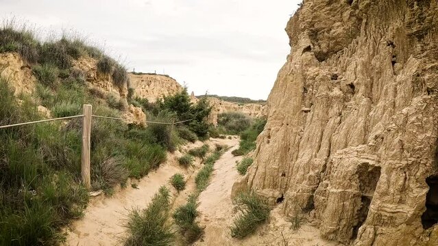 a narrow dirt path across the natural sculptures at Aguarales de Valdemilaz, Valpalmas, comarca of Cinco Villas, province of Zaragoza, Aragon, Spain