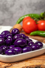 Purple or blueberry olives. Purple olives for breakfast in a plate