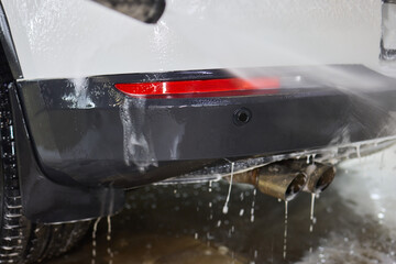 Foam covers car in garage tires, wheels, lights, hood, automotive design