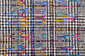 Abstract multicolored textile background texture with stitches.