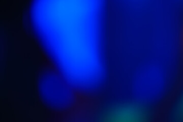 Abstract image with dark blue soft undefined shapes on a black background.